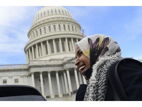 Rep.-elect Ilhan Omar, D-Minn., smiles during an interview following a photo opportunity on Capitol Hill in Washington, Wednesday, Nov. 14, 2018, with the freshman class.