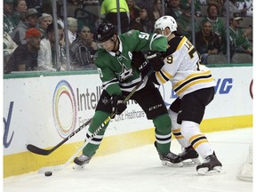 Dallas Stars center Jason Spezza (90) battles Boston Bruins defenseman Jeremy Lauzon (79) for the puck in the first period of an NHL hockey game Friday, Nov. 16, 2018, in Dallas.