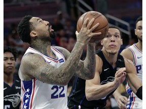 Philadelphia 76ers' Wilson Chandler (22) looks for a shot in front of Orlando Magic's Aaron Gordon, right, during the first half of an NBA basketball game Wednesday, Nov. 14, 2018, in Orlando, Fla.