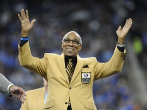 FILE - In this Oct. 18, 2015, file photo, former Detroit Lions defensive back Lem Barney acknowledges the crowd after receiving a Pro Football Hall of Fame ring during halftime of an NFL football game in Detroit. Barney and his wife are suing a Detroit-area pizza chain for racial discrimination after being refused service. The lawsuit filed in Detroit's federal court Monday, Nov. 12, 2018, says Lem and Jacqueline Barney went to Happy's Pizza in Commerce Township Nov. 2. The lawsuit says that when they tried to order, the manager told them to go to Happy's Southfield location because "they would be more at home there." The Barneys are black. Southfield has a majority black population and Commerce Township is mostly white.