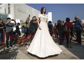 People look at a statue of Israel's Culture and Sports minister Miri Regev in Tel Aviv, Thursday ,Nov. 8, 2018. Israeli artist Itay Zalait set up his depiction of Regev as a protest of her pushing for legislation mandating "loyalty" in cultural works. AP Photo/Oded Balilty)