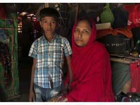 Rohingya refugees Sitara Begum with her son Mohammed Abbas, who are in the list for repatriation wait in their shelter at Jamtoli refugee camp, near Cox's Bazar, Bangladesh, Thursday, Nov. 15, 2018. Bangladesh authorities said Thursday that repatriation to Myanmar of some of the more than 700,000 Rohingya Muslims who fled army-led violence will begin as scheduled if people are willing to go, despite calls from United Nations officials and human rights groups for the refugees' safety in their homeland to be verified first.