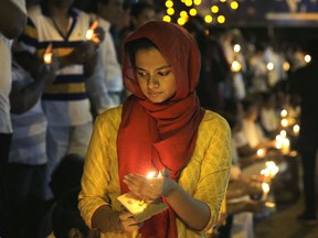 Pro- democratic Sri Lankans take part in a candle light vigil in Colombo, Sri Lanka, Sunday, Nov. 11, 2018. The crowd demanded the restoration of democracy after President Maithripala Sirisena dissolved Parliament and called for fresh elections.