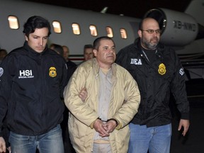 In this Jan. 19, 2017 file photo provided U.S. law enforcement, authorities escort Joaquin "El Chapo" Guzman from a plane to a waiting caravan of SUVs at Long Island MacArthur Airport, in Ronkonkoma, N.Y.