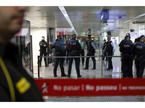 Mossos d'Esquadra regional police in Catalonia cordon off one of the entrance at the city's main train station in Barcelona, Spain, Wednesday, Nov. 7, 2018. Authorities in Barcelona say the city's main train station has re-opened after it closed for more than one hour at Wednesday's rush hour while police searched for possible explosives in a suspicious suitcase.