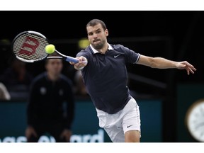 Bulgaria's Grigor Dimitrov returns the ball to Croatia's Marin Cilic during their third round match of the Paris Masters tennis tournament at the Bercy Arena in Paris, France, Thursday, Nov. 1, 2018.