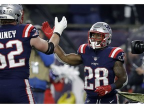 New England Patriots running back James White, right, celebrates his touchdown run with Joe Thuney, left, during the first half of an NFL football game against the New England Patriots, Sunday, Nov. 4, 2018, in Foxborough, Mass.