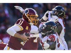 Atlanta Falcons defensive tackle Grady Jarrett, right, sacks Washington Redskins quarterback Alex Smith (11) during the first half of an NFL football game, Sunday, Nov. 4, 2018 in Landover, Md.