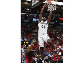 New Orleans Pelicans forward Solomon Hill dunks against Miami Heat guard Wayne Ellington during the first half of an NBA basketball game Friday, Nov. 30, 2018, in Miami.