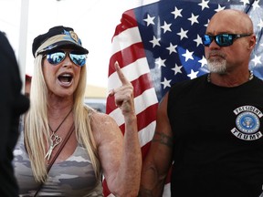 Protesters who refuse to give their names, chant outside of the Broward County Supervisor of Elections office during a recount on Sunday, Nov. 11, 2018, in Lauderhill, Fla.