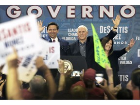 FILE- IN This Oct. 25, 2018 file photo Florida Republican gubernatorial candidate Ron DeSantis waves to the crowd at his Jacksonville, Fla., campaign rally where he was joined by Vice President Mike Pence and his wife Karen Pence. In the past, Florida's top races were tug-of-wars over taxes and education and insurance. This time around the governor's race is a proxy battle between President Donald Trump, who brought GOP gubernatorial nominee DeSantis to prominence and Democrats who oppose him.