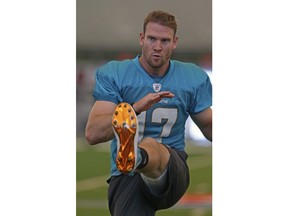 FILE - In this Nov. 1, 2018, file photo, Miami Dolphins quarterback Ryan Tannehill (17) runs drills during practice in Davie, Fla. The Miami Dolphins return from their bye hoping injured quarterback Ryan Tannehill can return this week against the Indianapolis Colts. Tannehill has missed the past five games with a shoulder injury, and Brock Osweiler has started in his place for coach Adam Gase's 5-5 team.