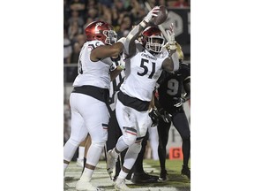 Cincinnati defensive end Kimoni Fitz (51) is congratulated by defensive tackle Cortez Broughton, left, after recovering a fumble in the end zone for a touchdown, following a sack of Central Florida quarterback McKenzie Milton during the first half of an NCAA college football game Saturday, Nov. 17, 2018, in Orlando, Fla.