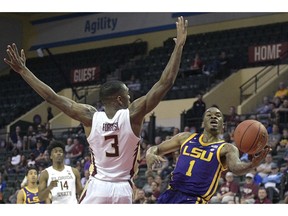 LSU guard Ja'vonte Smart (1) puts up a shot in front of Florida State guard Trent Forrest (3) during the first half of an NCAA college basketball game Friday, Nov. 23, 2018, in Lake Buena Vista, Fla.