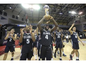 Villanova guard Phil Booth (5) celebrates with the championship trophy after getting a 66-60 win over Florida State in the championship game of an NCAA college basketball tournament Sunday, Nov. 25, 2018, in Lake Buena Vista, Fla.