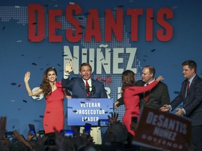 Republican Florida Governor-elect Ron DeSantis, center, waves to the supporters with his wife, Casey, left, and Republican Lt. Governor-elect Jeanette Nunez, third right, after thanking the crowd Tuesday, Nov. 6, 2018, in Orlando, Fla. DeSantis defeated Democratic candidate Andrew Gillum.