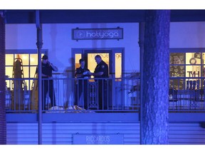 Police investigators work the scene of a shooting, Friday, Nov. 2, 2018, in Tallahassee, Fla.  A shooter killed one person and critically wounded four others at a yoga studio in Florida's capital before killing himself Friday, officials said.