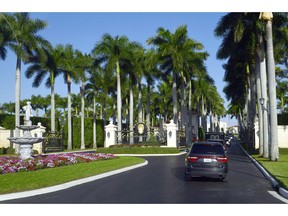 The motorcade with President Donald Trump, drives into the Trump International Golf Club in West Palm Beach, Fla., Wednesday, Nov. 21, 2018.