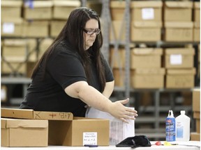 An employee unpacks boxes of ballots before resuming a recount at the Palm Beach County Supervisor Of Elections office, Thursday, Nov. 15, 2018, in West Palm Beach, Fla.  A federal judge slammed Florida on Thursday for repeatedly failing to anticipate election problems, and said the state law on recounts appears to violate the U.S. Supreme Court ruling that decided the presidency in 2000.