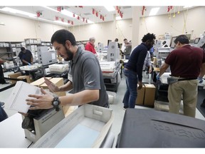 Employees at the Broward County Supervisor of Elections office recount ballots, Wednesday, Nov. 14, 2018, in Lauderhill, Fla.