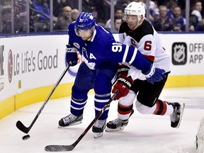 Toronto Maple Leafs centre John Tavares (91) moves the puck around the back of the net as New Jersey Devils defenceman Andy Greene (6) gives chase during third period NHL action in Toronto on Friday, Nov. 9, 2018.
