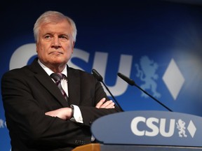 FILE - In this Oct. 15, 2018 file photo German Interior Minister and CSU chairman Horst Seehofer attends a press conference at the headquarters of the Christian Social Union, CSU, in Munich, Germany. Germany's top security official, who has frequently criticized Chancellor Angela Merkel's migrant policy, is reportedly planning to quit his post in government. German news agency dpa quoted multiple unnamed party officials as saying Horst Seehofer told a meeting of the Christian Social Union on Sunday that he plans to relinquish its leadership and his role as interior minister in Merkel's government.
