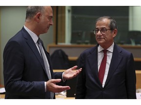 Italian Finance Minister Giovanni Tria, right, talks to European Commissioner for Economic and Financial Affairs Pierre Moscovici prior to a meeting of Eurogroup Finance Ministers at the European Council headquarters in Brussels, Monday, Nov. 5, 2018. Finance Ministers from the 19 nations using the euro currency gather in Brussels on Monday to debate draft budget plans amid tensions over whether Italy's planned spending package breaks promises to cut public debt.