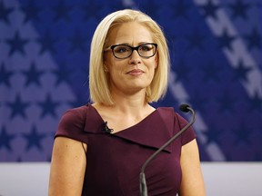 FILE - In this Oct. 15, 2018 file photo, U.S. Rep. Kyrsten Sinema, D-Ariz., goes over the rules in a television studio prior to a televised debate with U.S. Rep. Martha McSally, R-Ariz., in Phoenix. Sinema won Arizona's open U.S. Senate seat Monday, Nov. 12, in a race that was among the most closely watched in the nation, beating Republican Rep. Martha McSally in the battle to replace GOP Sen. Jeff Flake.
