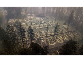 FILE - In this Thursday, Nov. 15, 2018, file photo, residences leveled by the wildfire line a neighborhood in Paradise, Calif. Officials say the search to find the missing and identify victims could take months given the size and scope of the deadly wildfire that swept Northern California's Gold Rush country. The Camp Fire in Butte County that started two weeks ago has killed dozens of people with the number increasing daily.