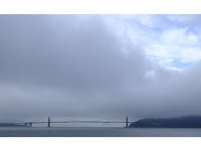 A break in the weather appears over the Golden Gate Bridge Wednesday, Nov. 28, 2018, in San Francisco. Forecasters say California will see widespread rain and heavy Sierra Nevada snowfall starting late Wednesday that could create travel problems and unleash damaging runoff from wildfire burn scars.