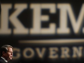 Georgia Republican gubernatorial candidate Brian Kemp speaks with supporters after a long election night in Athens, Ga., Wednesday, Nov. 7, 2018. Georgia's hotly contested and potentially historic governor's race may not be over yet, with Democrat Stacey Abrams and Kemp awaiting the final accounting of absentee and provisional ballots.