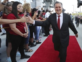 FILE - In this May 9, 2018, file photo, Atlanta United coach Gerardo "Tata" Martino high-fives fans while leading the team arrival for an MLS soccer match against Sporting Kansas City, in Atlanta.  Martino has been voted coach of the year in Major League Soccer. Martino won his first award after guiding Atlanta through another record-breaking season.