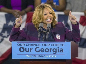 CORRECTS THAT REPUBLICAN REP. KAREN HANDEL FACED A RISK OF LOSING HER SEAT, NOT MCBATH, HER CHALLENGER - FILE - In a Friday, Nov. 2, 2018 file photo, Democrat Lucy McBath speaks during a rally for Democratic gubernatorial candidate Stacey Abrams, at Morehouse College in Atlanta. Republican Rep. Karen Handel faced and GOP Rep. Rob Woodall faces a risk of losing their seats Wednesday, Nov. 7, 2018, as election returns showed them in perilously tight races with Democratic challengers in a pair of suburban Atlanta districts long considered safe for the GOP.