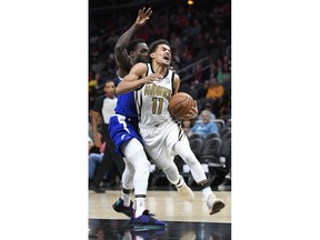 Atlanta Hawks guard Trae Young (11) drives past defending Los Angeles Clippers guard Patrick Beverley during the first half of an NBA basketball game Monday, Nov. 19, 2018, in Atlanta.