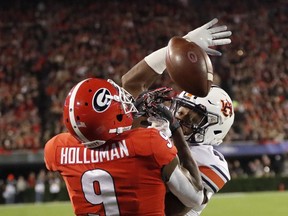 Auburn defensive back Noah Igbinoghene breaks up a pass intended for Georgia wide receiver Jeremiah Holloman (9) during the first half of an NCAA college football game Saturday, Nov. 10, 2018, in Athens, Ga.