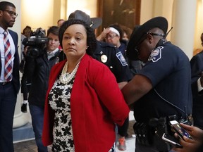 Sen. Nikema Williams (D-Atlanta) is arrested by capitol police during a protest over election ballot counts in the rotunda of the state capitol building Tuesday, Nov. 13, 2018, in Atlanta. Dozens filled the rotunda in the center of the Capitol's second floor Tuesday just as the House was scheduled to convene for a special session.