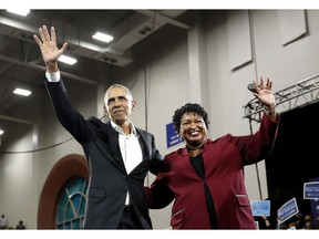 Former President Barack Obama and Democratic candidate for Georgia Goveernor Stacey Abrams wave to the crowd during a campaign rally at Morehouse College Friday, Nov. 2, 2018, in Atlanta.