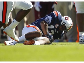 Auburn defensive back Jamel Dean (12) recovers a fumble against Texas A&M during the first half of an NCAA college football game, Saturday, Nov. 3, 2018, in Auburn, Ala.