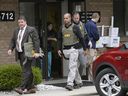 In this April 21, 2017 file photo, FBI agents leave Dr. Fakhruddin Attar's office at the Burhani Clinic in Livonia, Michigan, after completing a document search. 