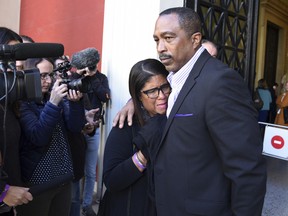 Husband and with Phil and Jill Henderson, parents of Bakari Henderson, face the media outside the court house in Patras, Greece, on Thursday, Nov. 22, 2018.