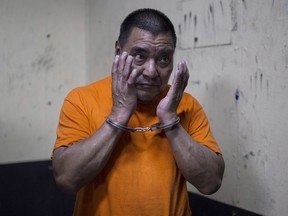 In this Aug. 10, 2016 file photo, Santos Lopez Alonzo stands in a courtroom as he waits for his first hearing in Guatemala City.