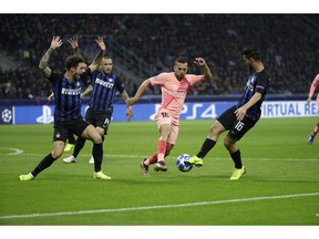 Barcelona defender Jordi Alba, second right, fights for the ball against Inter midfielder Matteo Politano, right, during the Champions League group B soccer match between Inter Milan and Barcelona at the San Siro stadium in Milan, Italy, Tuesday, Nov. 6, 2018.