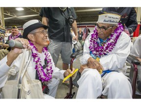 FILE - In this Dec. 7, 2016, file photo, Kathleen Chavez, left, talks with her father Ray Chavez, right, age 104, of the USS Condor, the oldest living survivor from the Pearl Harbor attacks along with the remaining living survivors of the USS Arizona gathered at the World War II Valor in the Pacific National Monument at Joint Base Pearl Harbor-Hickam in Honolulu. Ray Chavez, the oldest U.S. military survivor of the Dec. 7, 1941, attack on Pearl Harbor that plunged the United States into World War II has died at age 106. Chavez's daughter, Kathleen Chavez of Poway, Calif., tells The Associated Press her father died in his sleep Wednesday, Nov. 21, 2018.