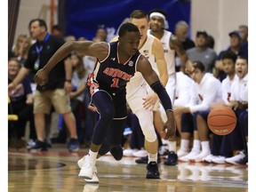Auburn guard Jared Harper (1) steals the ball away from Xavier forward Ryan Welage during the first half of a NCAA college basketball game at the Maui Invitational, Monday, Nov. 19, 2018, in Lahaina, Hawaii.