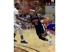 Auburn guard Bryce Brown (2) drives past Xavier forward Naji Marshall (13) during overtime in an NCAA college basketball game at the Maui Invitational, Monday, Nov. 19, 2018, in Lahaina, Hawaii. Auburn defeated Xavier 88-79.