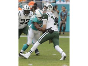 Miami Dolphins defensive end Cameron Wake (91) sacks New York Jets quarterback Sam Darnold (14), during the first half of an NFL football game, Sunday, Nov. 4, 2018, in Miami Gardens, Fla. New York Jets offensive tackle Brandon Shell (72) is on the left.