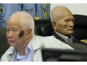 FILE - In this Oct. 31, 2013, file photo released by the Extraordinary Chambers in the Courts of Cambodia, Khieu Samphan, left, former Khmer Rouge head of state, and Nuon Chea, right, who was the Khmer Rouge's chief ideologist and No. 2 leader, sit in the court hall at the U.N.-backed war crimes tribunal in Phnom Penh, Cambodia. The U.N.-assisted international tribunal in Cambodia judging former leaders of the Khmer Rouge for their roles in abuses that led to the deaths of an estimated 1.7 million of their countrymen will issue verdicts Friday, Nov. 16, 2018,  in the latest - and perhaps last - of such trials.  Nuon Chea, 92, and Khieu Samphan, 87, are the last two surviving senior leaders of the radical communist group that brutally ruled Cambodia in the late 1970s.