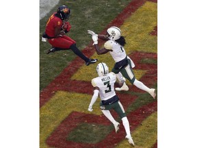 Iowa State wide receiver Deshaunte Jones (8) leaps to catch a touchdown pass over Baylor safeties Verkedric Vaughns, right, and Chris Miller, bottom, during the first half of an NCAA college football game, Saturday, Nov. 10, 2018, in Ames.