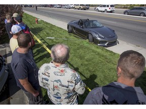 FILE--In this Sept. 16, 2017, file photo, bystanders look on as police block off the scene were the driver of a Porsche injured eight bystanders after losing control of the sports car near the Boise Spectrum 21 theaters in Boise, Idaho. The driver of the Porsche has been sentenced to 180 days in jail with all but seven days suspended.