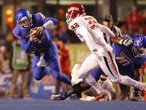 Boise State quarterback Brett Rypien (4) is tripped up by a Fresno State play for a loss during an NCAA college football game Friday, Nov. 9, 2018, in Boise, Idaho.
